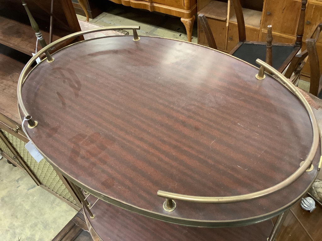 A brass mounted simulated rosewood oval two tier tea trolley, c.1970, width 70cm depth 45cm height 68cm